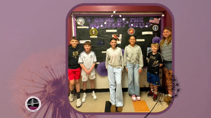 HFIS students proud to stand in front of the Bulletin Board