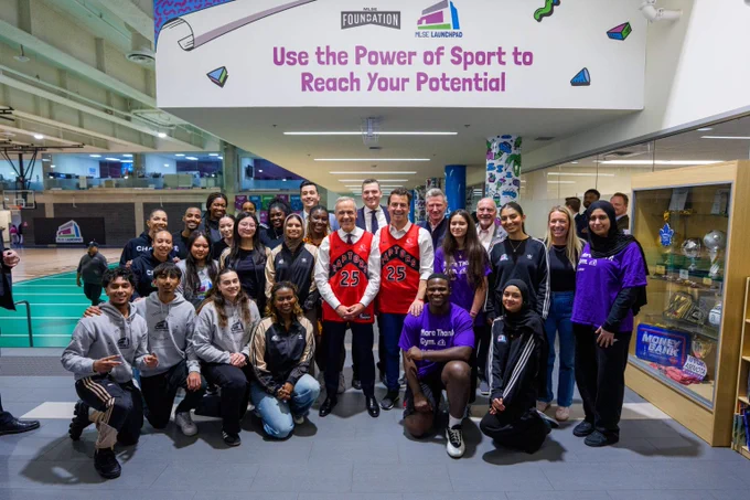 Prime Minister Mark Carney, the Secretary of State for Sport, Adam van Koeverden, Minister Evan Solomon, and others stand alongside young Canadians at the MLSE Launchpad youth recreation complex in Toronto.  