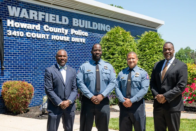 County Executive Calvin Ball (far right) posed out front of the Howard County Police Department's Northern District Warfield Building in Ellicott City with (from left to right) Howard County Council Chairperson Opel Jones, Acting Chief Terrence Benn, and Acting Colonel Antonio Thomas.