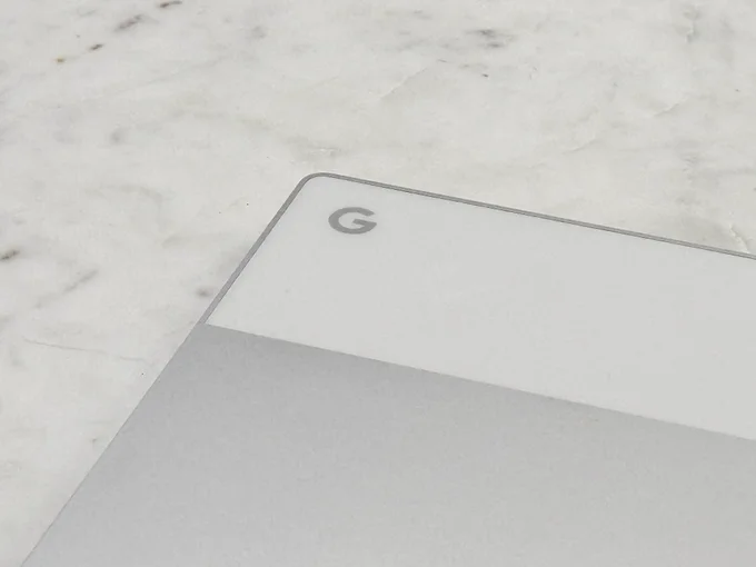 Pixelbook on table. Big G in center