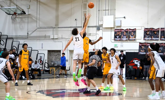 Ryan Doane and Yann Kamagate tip-off at center court for the coveted matchup between Compton Magic 17u and Team CPSA 17u.