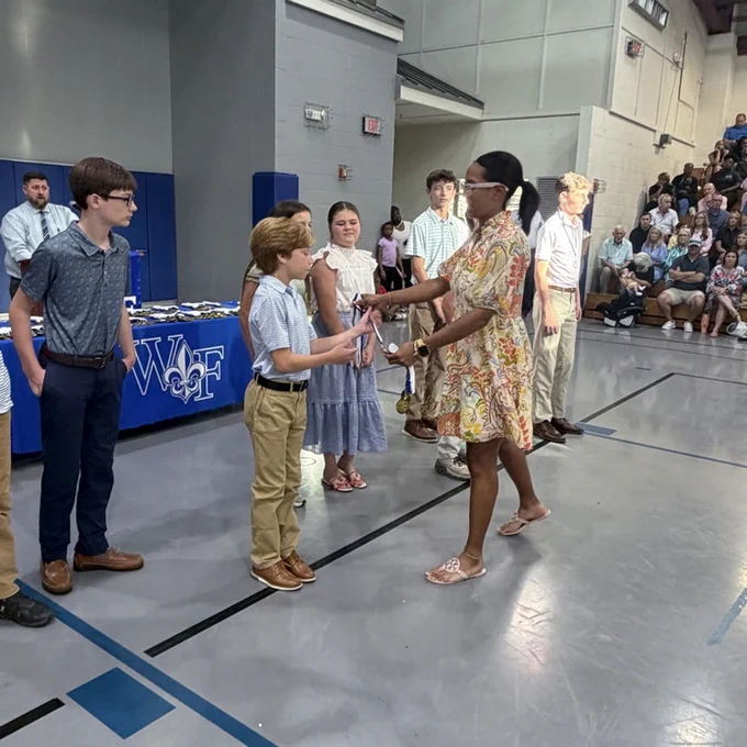 Coach gives athlete a medal