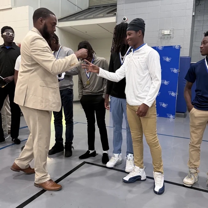Coach gives athlete a medal