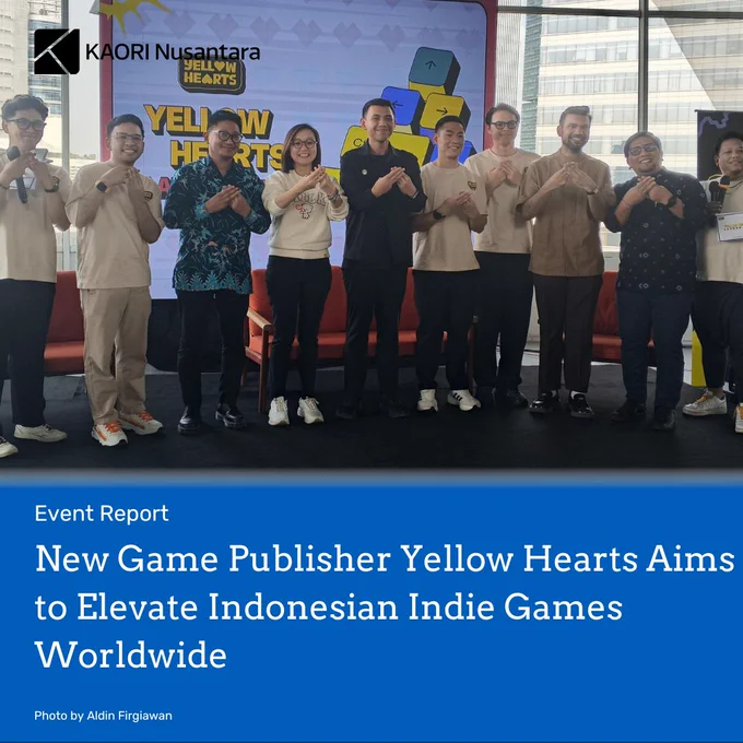 Header image from an article titled "New Game Publisher Yellow Hearts Aims to Elevate Indonesian Indie Games Worldwide". The article title is written in white over blue background in the bottom half of the image. The picture shows the activity at the event. Copyright attributionPhoto by Aldin Firgiawan on the bottom left. The article is tagged "Event Report". The logo of KAORI Nusantara is on top left in black.