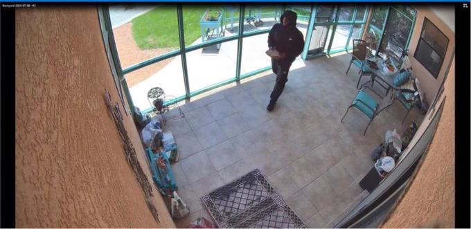 A surveillance photo of the defendant after he used a brick to break into a victim's home in New Mexico.