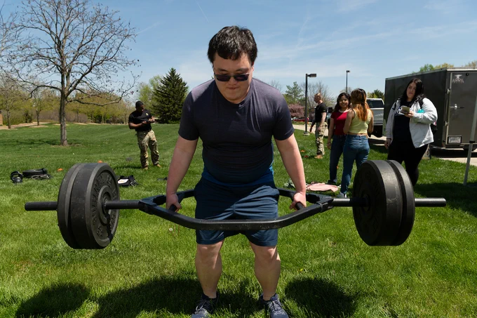 a man lifting weights outside