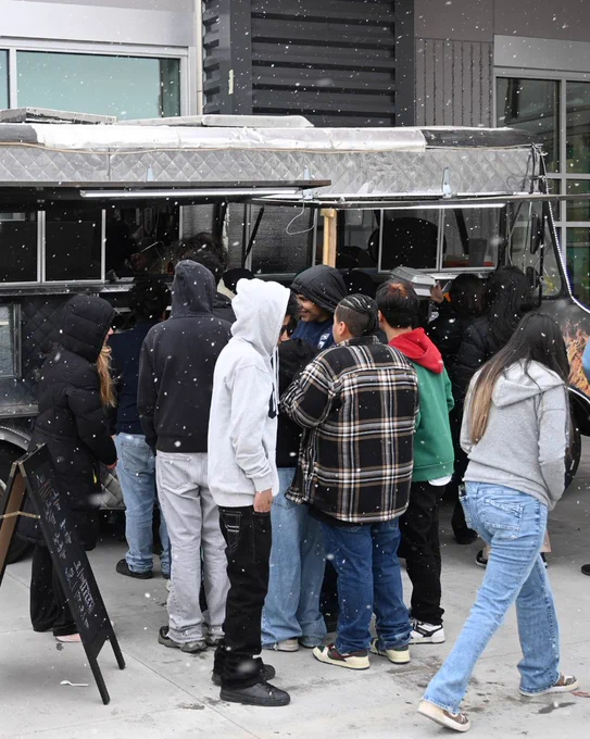 students stand at food truck
