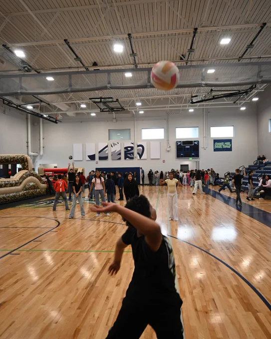 student hits a volleyball