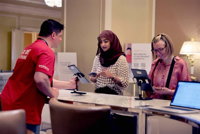 Individuals check in for VISION: Elevate using tablet computers