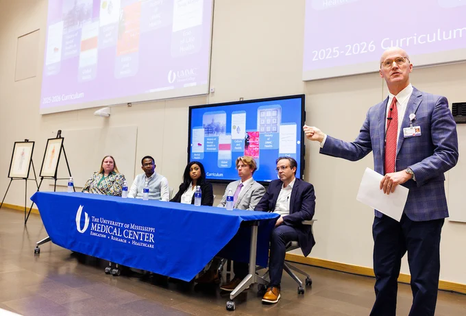Dr. Scott Rodgers, associate vice chancellor for academic affairs (in the foreground), introduces the UMMC Honors College curriculum, while student panelists look on.