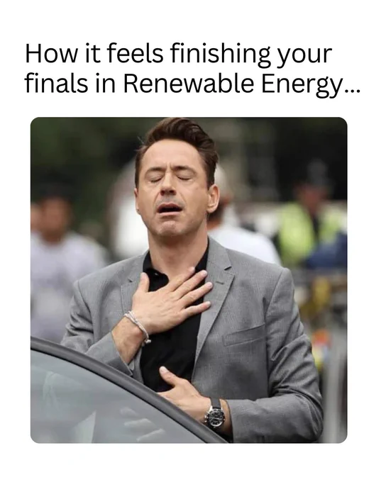 Person in a gray blazer clutching chest with a relieved expression, symbolizing the feeling after finishing Renewable Energy finals.