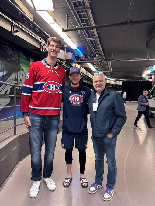 Olivier Rioux in a Canadiens jersey posing for a photo with Jakub Dobes who is in Canadiens athletic wear.
