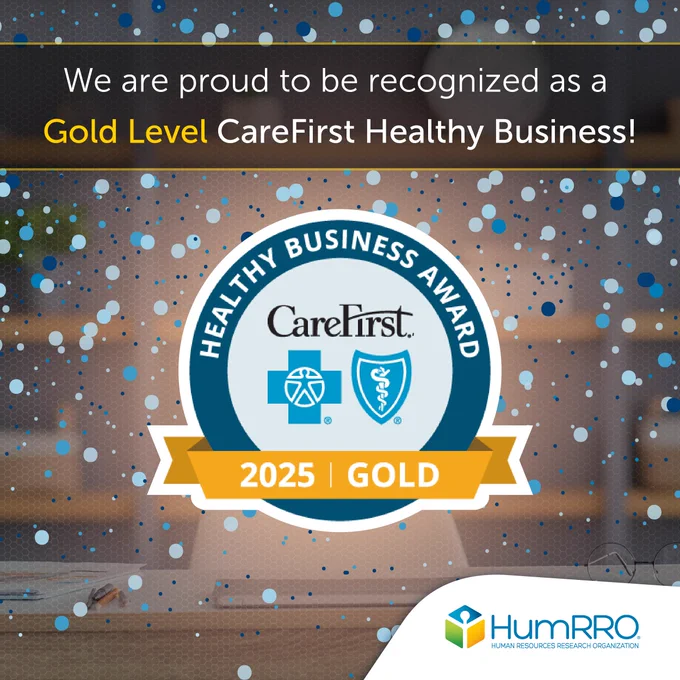 Graphic with a CareFirst Healthy Business Award 2025 Gold logo in the center with celebratory bubbles floating in the background and the HumRRO logo in the bottom right corner. Text: We are proud to be recognized as a Gold Level CareFirst Healthy Business!