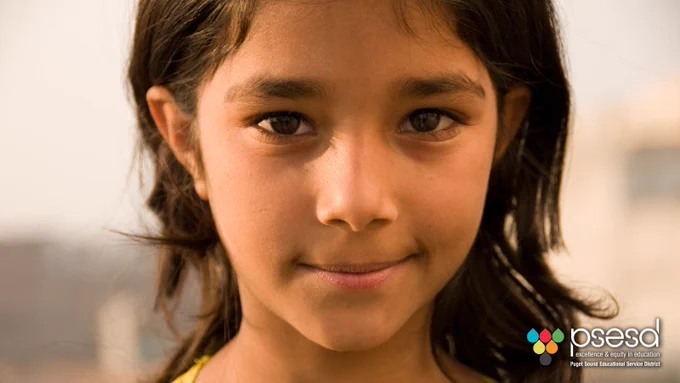 A little girl of asian descent smiles for the camera.