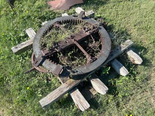 An image of a circular piece of farm equipment like a gear.