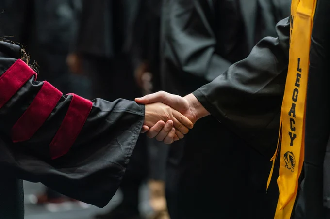 Two people shake hands
