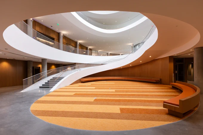 Lower level of the Barbara and Gerson Bakar Gateway, home of the UC Berkeley College of Computing, Data Science, and Society, featuring a modern oval staircase.
