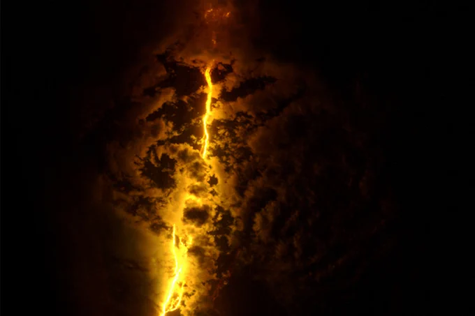 Fiery lava illuminating jagged fissures in a volcanic surface and ash above.