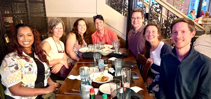 DFMCH Faculty and students pose for a photo while at dinner together
