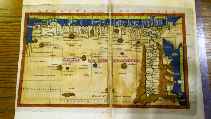 Pictured is a map of North Africa from 1482 that is sitting on a table in Special Collections.