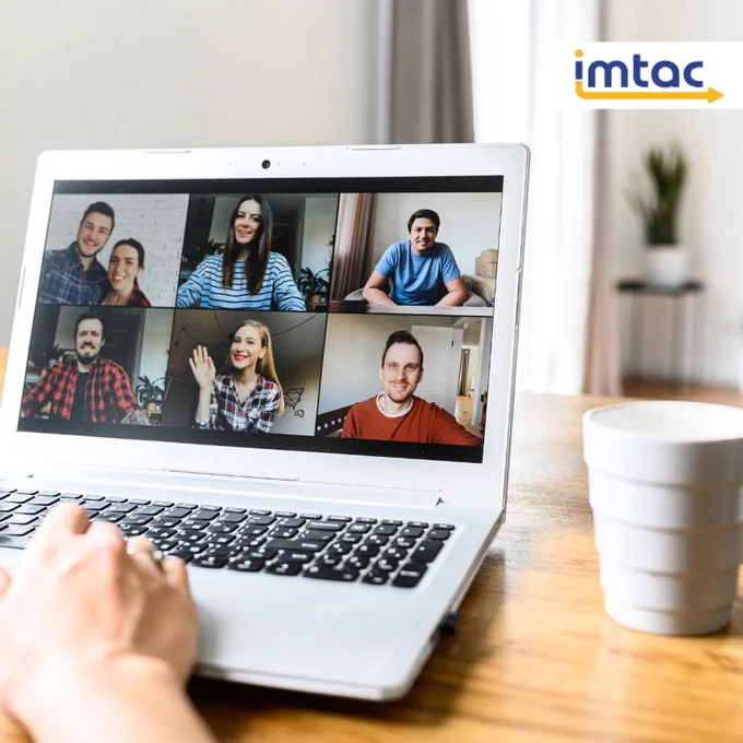 Stock image of a laptop monitor, with 7 people in a Zoom meeting.

Laptop is on a desk, with a cup of coffee to the right