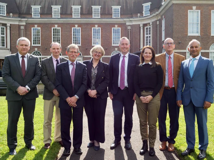 Image of Education Minister Paul Givan pictured with Jonathan Heggarty, Harold Hislop, Tim Oates CBE, Christine Counsell OBE, Dr Jennifer Buckingham, Daniel T. Willingham and Hardip Begol CBE.