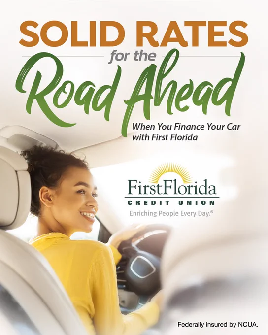 A person smiling while driving a car, with text promoting "Solid Rates for the Road Ahead" from First Florida Credit Union. It mentions benefits of financing your car with them and notes federal insurance by the NCUA.