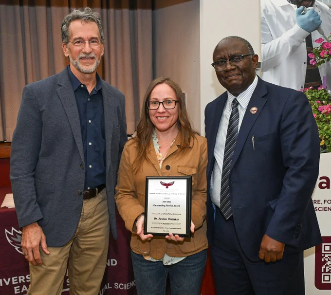 Department of Natural Sciences Outstanding Service Award winner Dr. Justine Whitaker with Dean Dr. Moses T. Kairo and Chair Dr. Jonathan Cumming at SANS end of the year awards event. 