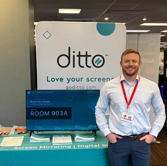 A man standing in front of the Ditto booth at the ACTEM Spring Leadership Conference.