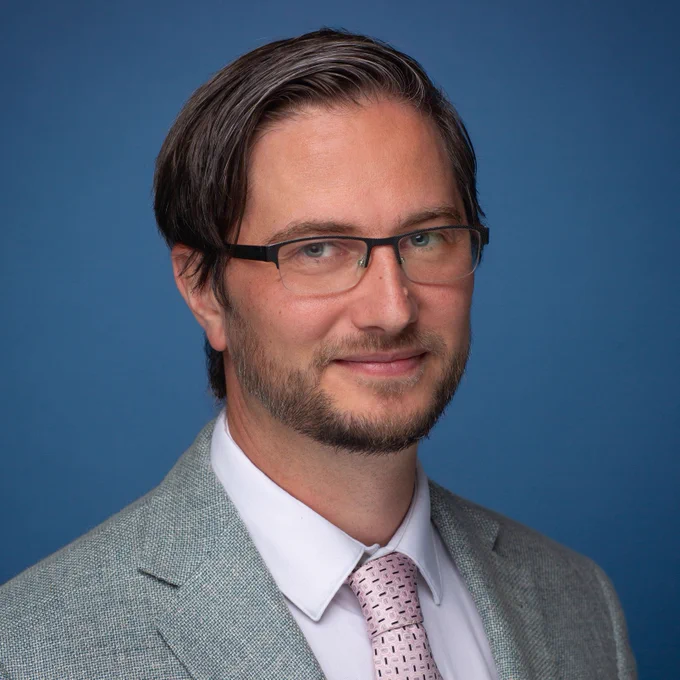 Man in suit and tie wearing glasses