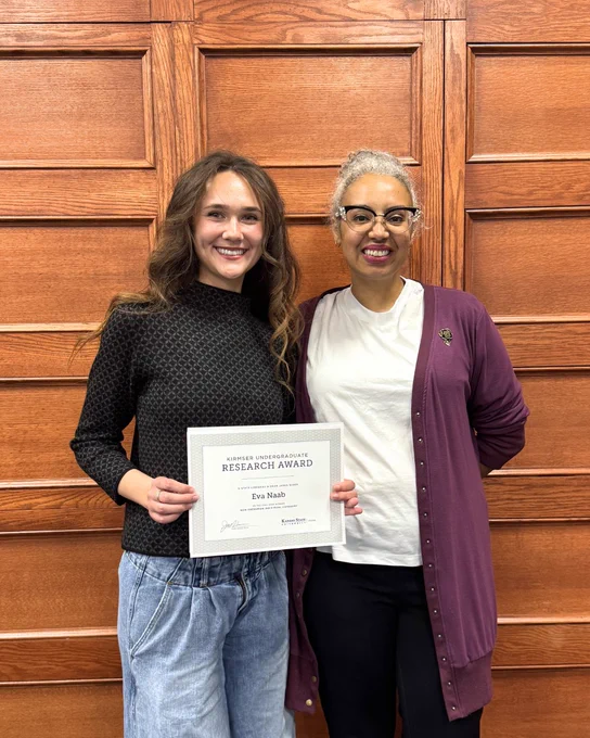 Kirmser Research Award recipient Eva Naab poses with her certificate alongside Associate Dean Tara Coleman.