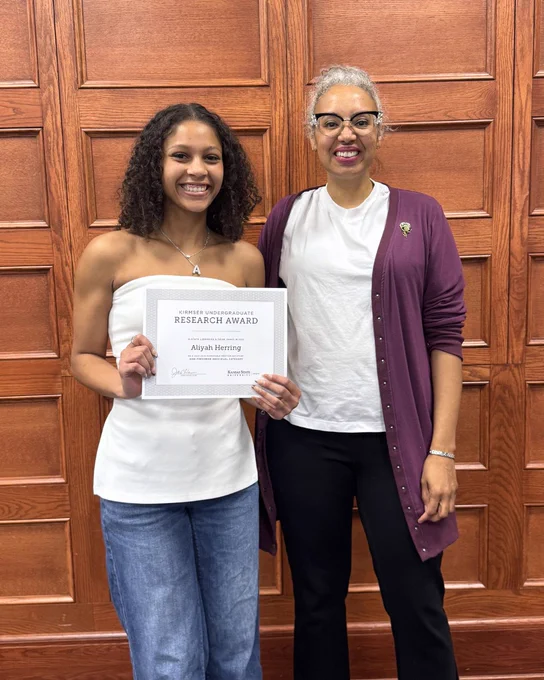 Kirmser Research Award recipient Aliyah Herring poses with her certificate alongside Associate Dean Tara Coleman.