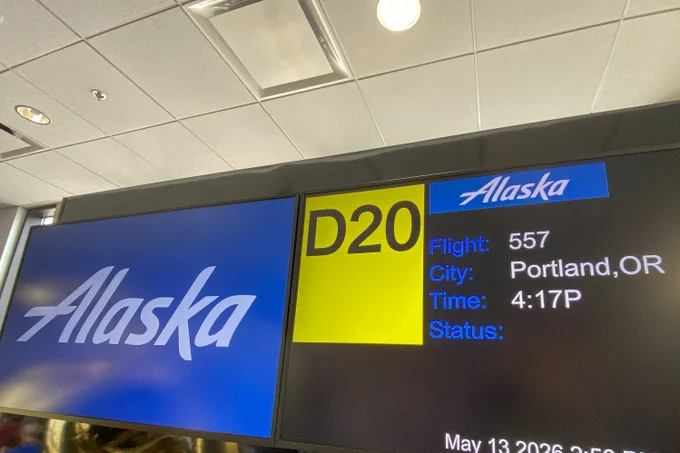 A gate information display screen at BWI Thurgood Marshall Airport for Alaska Airlines Flight 557 to Portland, Oregon.