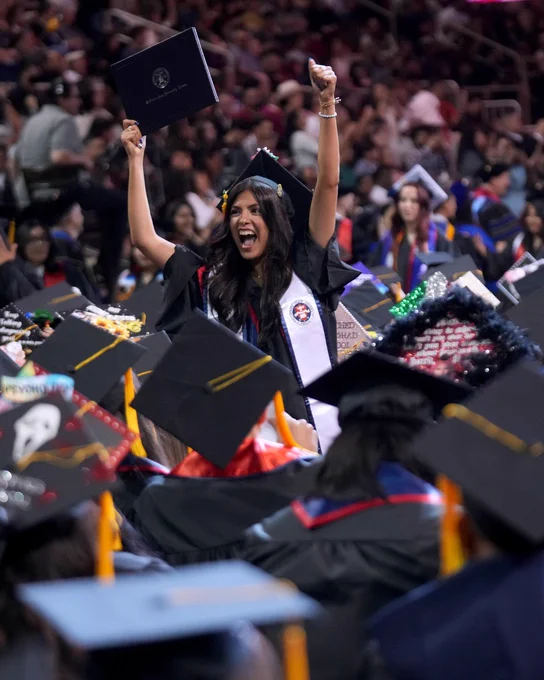 Student cheering at commencement.