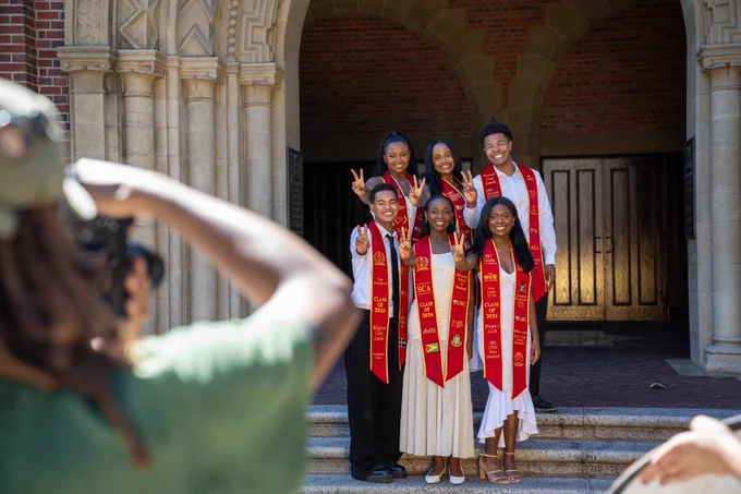 Students in Commencement regalia posing for a photo