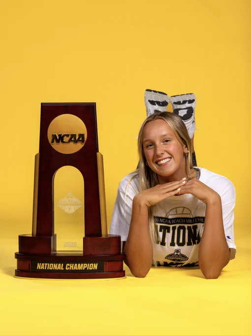 Maggie Boyd next to the NCAA championship trophy