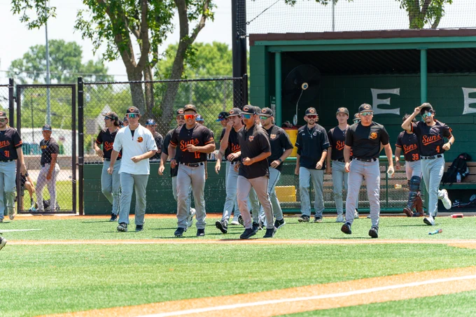 Dallas College Cedar Valley baseball players approach the playing field in between innings. 