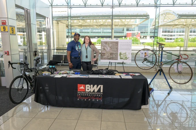 Stephen Snead and Kendall Selch at a bicycling-themed activation at BWI Thurgood Marshall Airport.