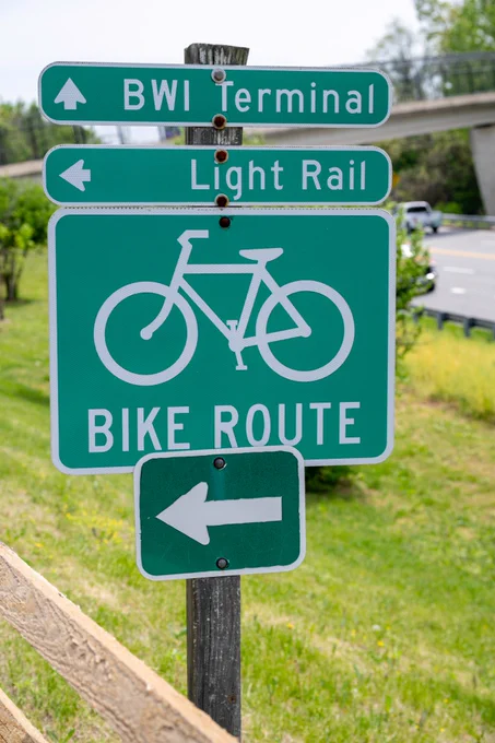 Sign along the BWI Trail giving visitors directions to the BWI terminal, Light Rail and bike route.