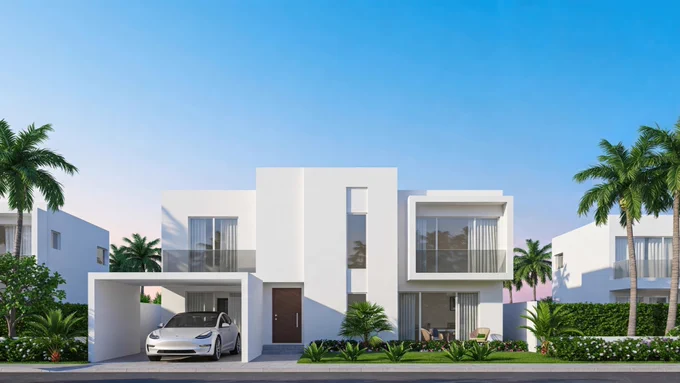 A modern white two-story house with large windows and a carport housing a Tesla. The property is surrounded by palm trees and greenery, and features a blue sky in the background.