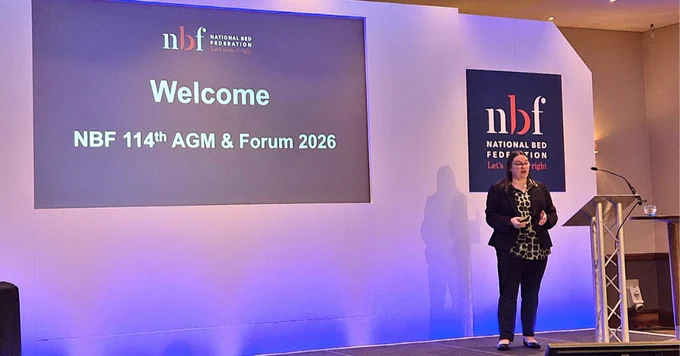 NBF Executive Director, Tristine Hargreaves,  addressing attendees at the National Bed Federation's 114th AGM and Spring Forum 2026 on stage.