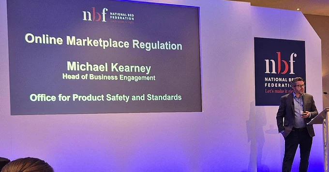 Michael Kearney presenting on stage on Online Marketplace Regulation at the National Bed Federation Spring Forum