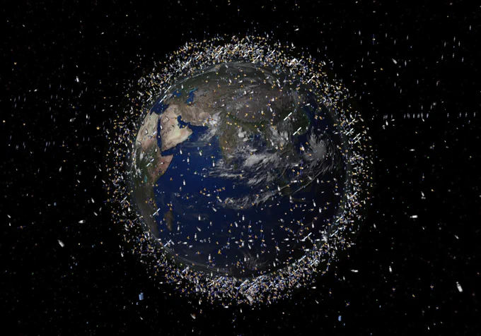 Earth from space surrounded by a dense ring of artificial space debris, including satellites and fragments. Credit: ESA