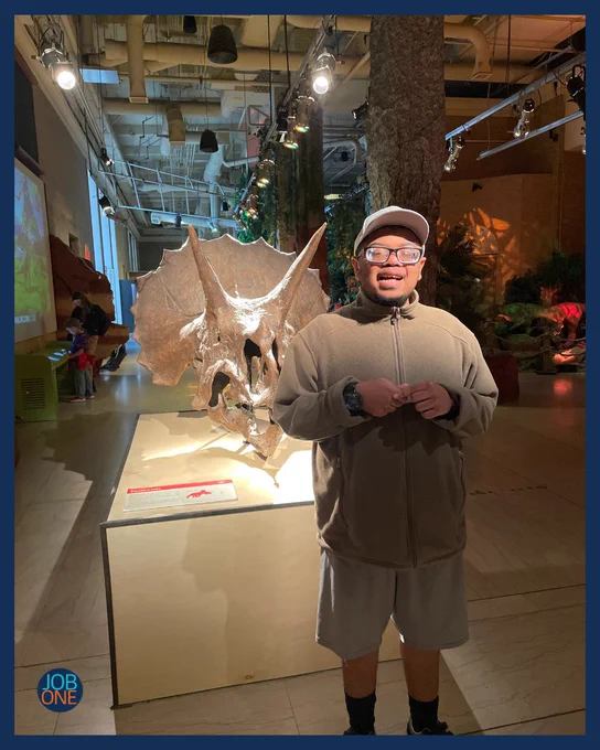 Monte is posing with a dinosaur at union station in Kansas City
