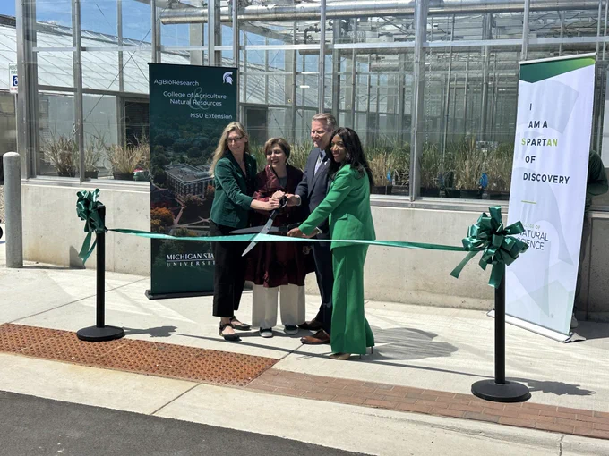 MSU leaders cutting the ribbon to the greenhouses.