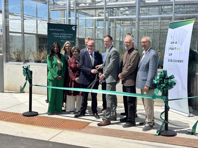 MSU leaders cutting the ribbon to the greenhouses.