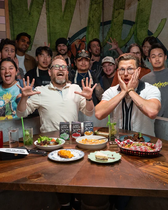Sam, Chef Josh, and crew on the set of Last Meals, making scared faces to camera.