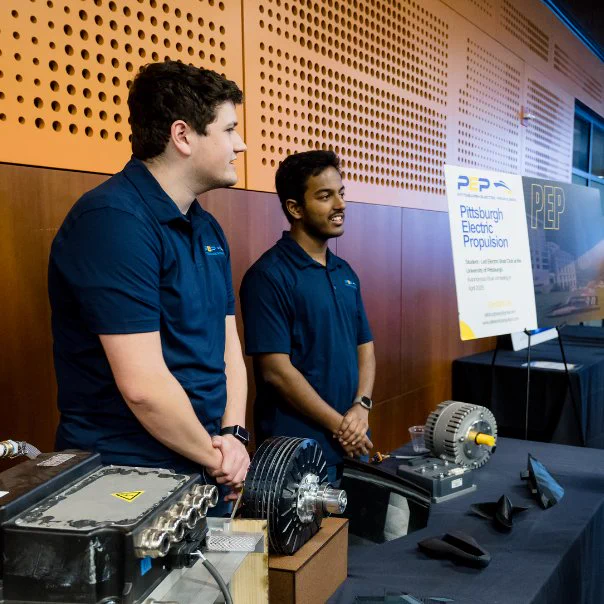 Rafayel Amirkhanyan and Soumik Chakraborty at a Pittsburgh Electric Propulsion table during a conference