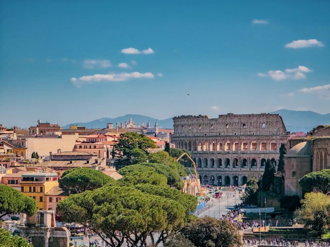 A breathtaking view of Rome featuring the iconic Colosseum on a sunny day.