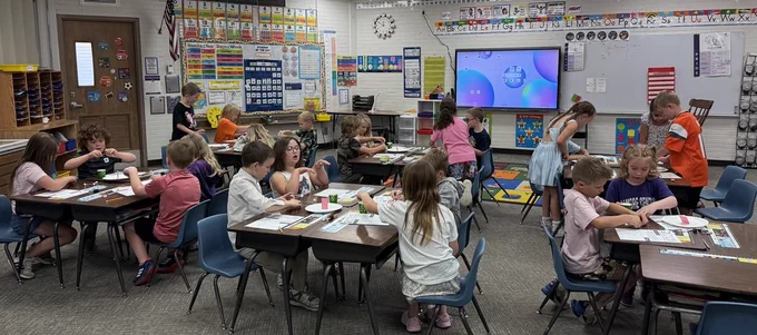 First graders reading the 3 little pigs. 